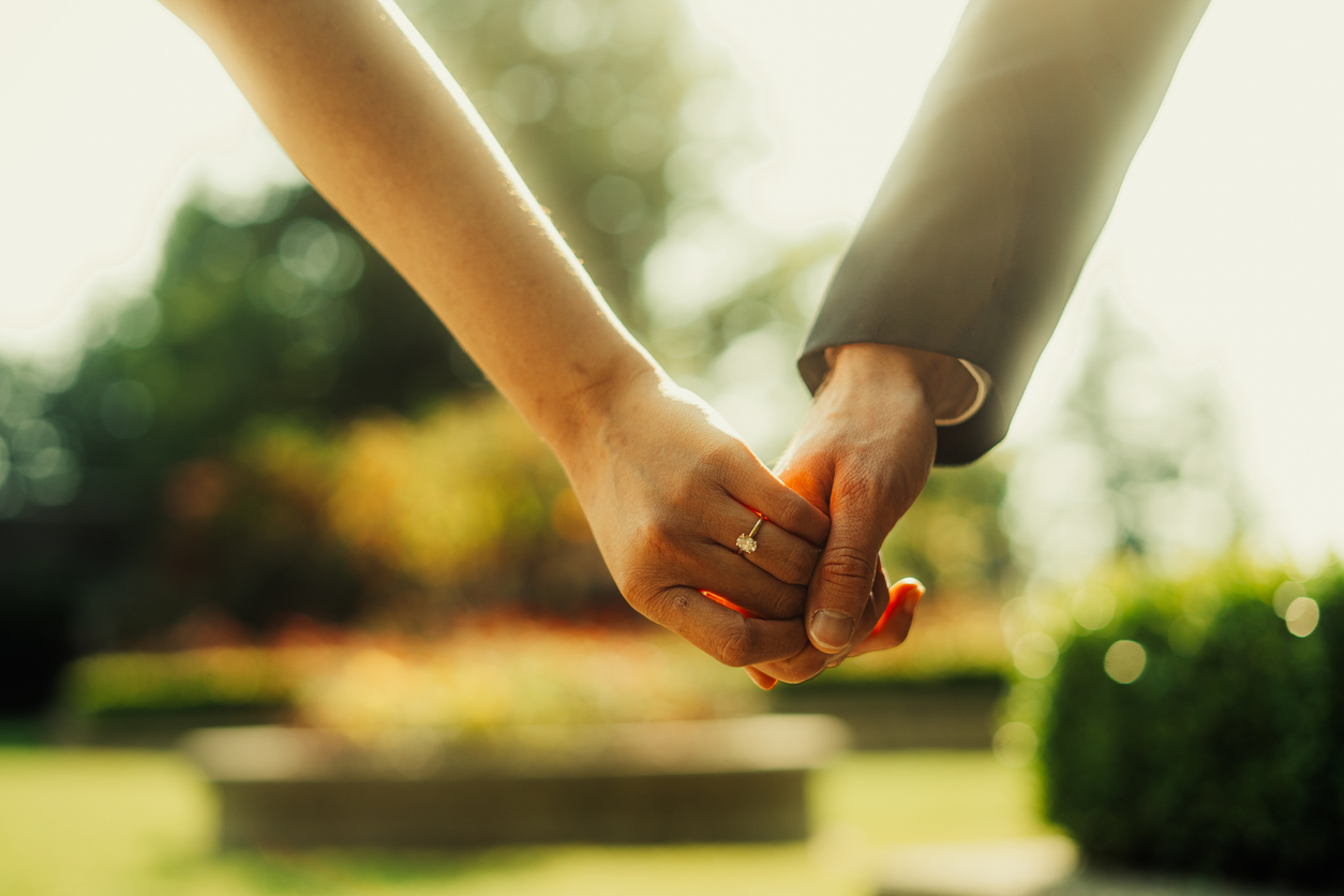 Horizontal Close-Up Shot of Married Couple Holding Hands cross border Canadian spouse