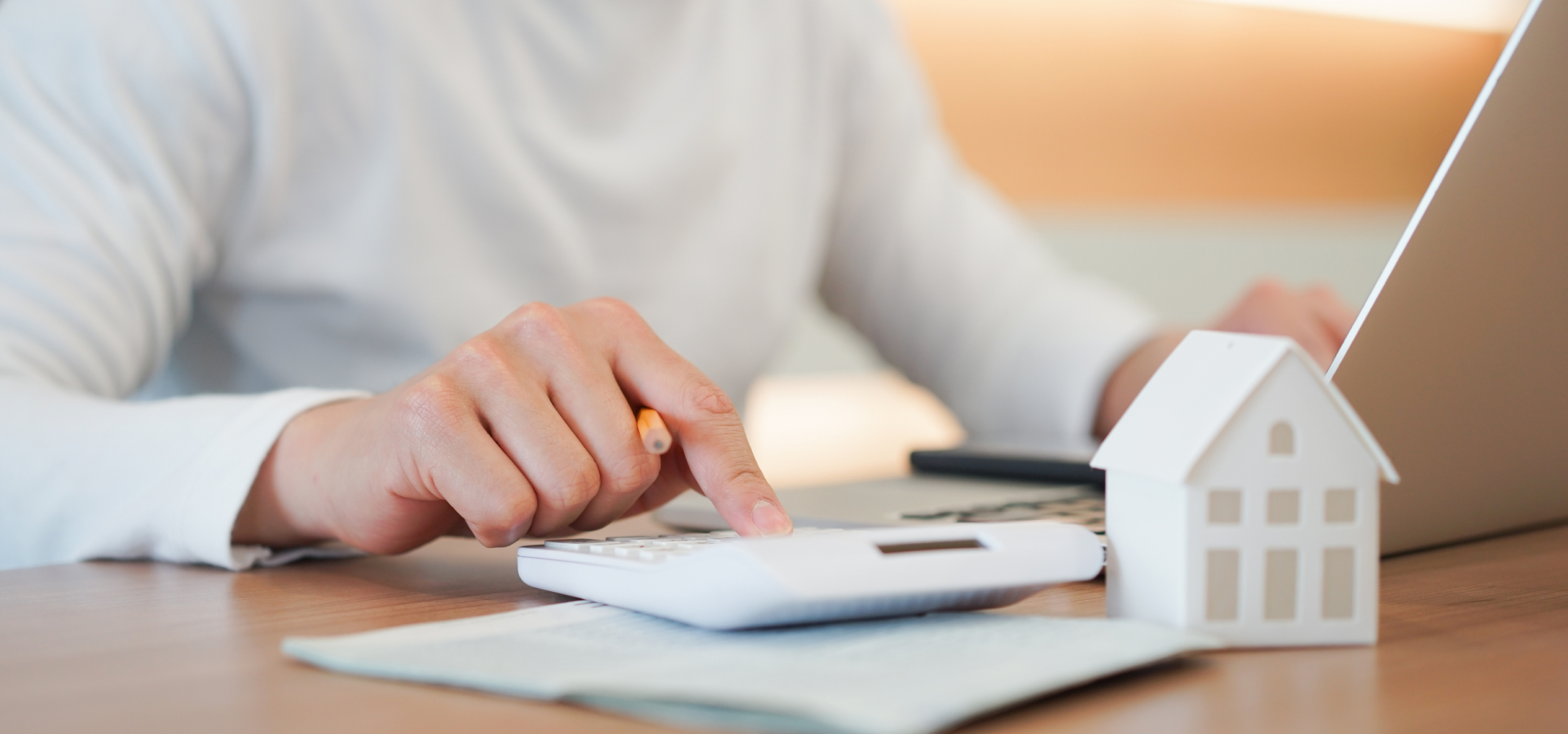 close up young man hand press on calculator to check and summary expense of home loan mortgage for refinance plan , people lifestyle concept Estate Planning